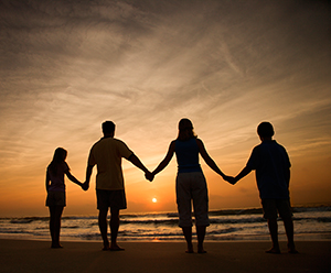 Family holding hands on the beach